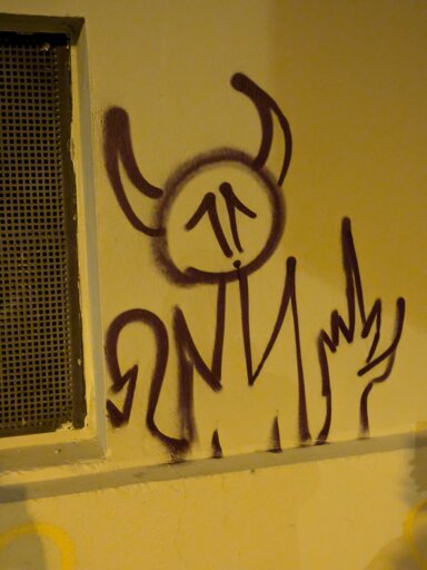 Sprayed devil or demon on a housewall