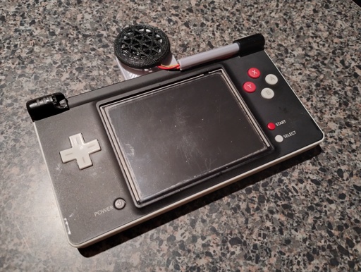 Photo: the bottom half of a Nintendo DSi modified to allow it to work as a handheld game system.